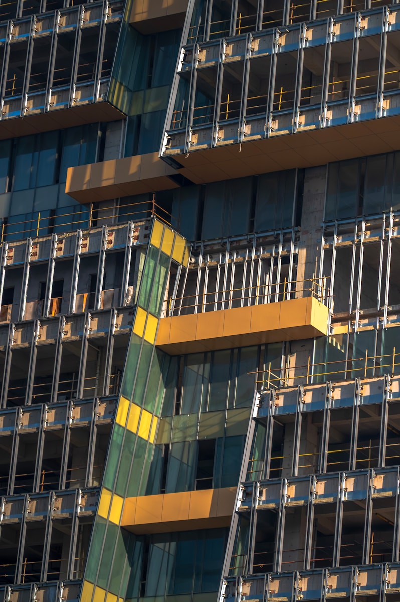Modern building under construction with yellow accents.